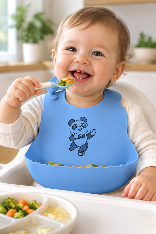 Baby wearing a blue silicone feeding bib with black outline-only panda print